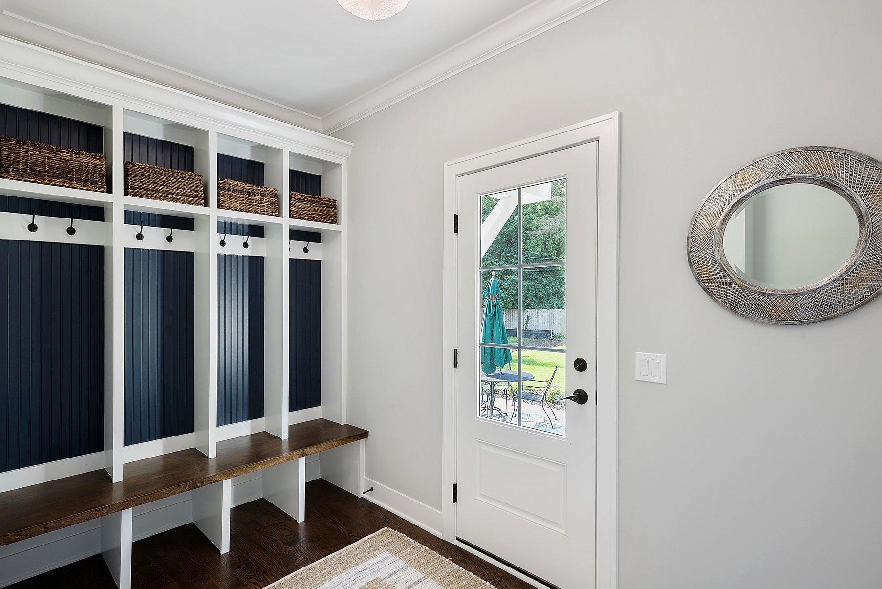 Mud room with four blue painted lockers